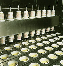 After cooling, the noodles are placed in styrofoam cups, and flavoring is added.